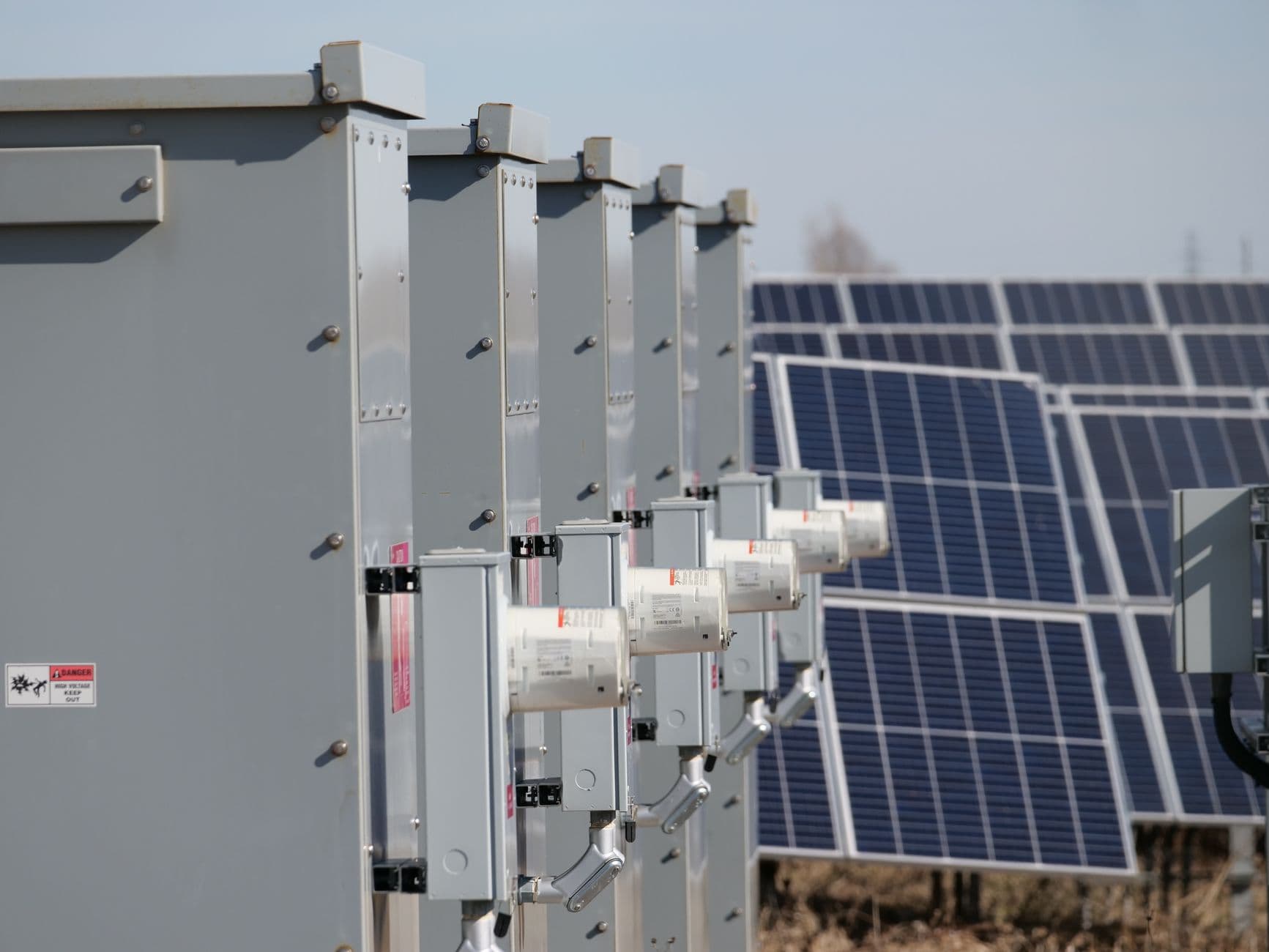 Close-up of outdoor electrical boxes connected to solar panels